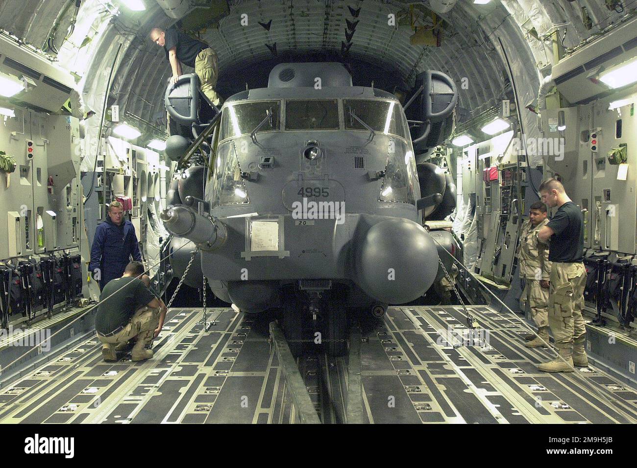 Les membres de l'escadre des opérations spéciales (ÉT) de 16th déchargent un hélicoptère MH-53J Pave Low d'un C-17 Globemaster III, à l'appui de l'opération ENDURING FREEDOM. Sujet opération/série: LIBERTÉ DURABLE pays: Scène inconnue Grand commandement illustré: AFSOC Banque D'Images