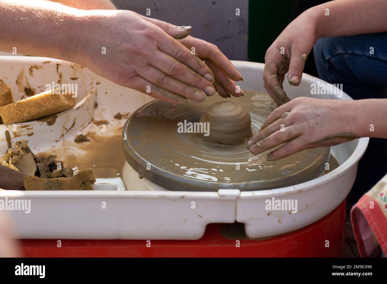 Préparer Un pot en argile sur la classe de poterie. Potier travaillant avec l'étudiant sur la roue de potiers faisant pot en céramique de l'argile dans l'atelier de poterie sur l'extérieur à non Banque D'Images