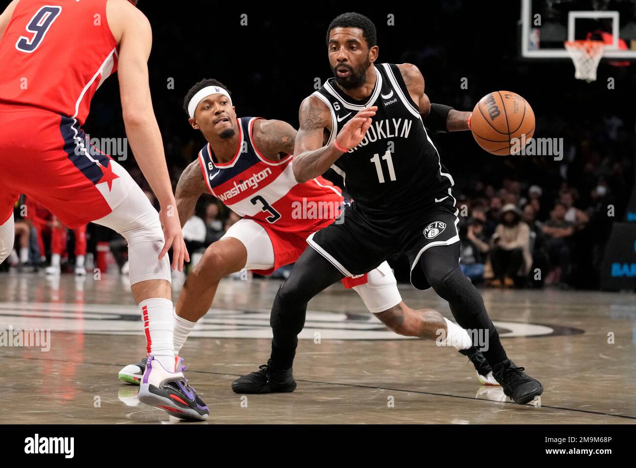 Brooklyn Nets guard Kyrie Irving (11) dribbles past Washington Wizards  guard Bradley Beal (3) during the