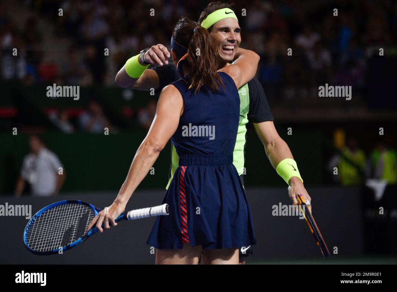 Former tennis player, Argentina's Gabriela Sabatini embraces her doubles  partner Spain's Rafael Nadal after they defeated former tennis player  Argentina's Gisela Dulko and Norway's Casper Ruud, at the end of an  exhibition