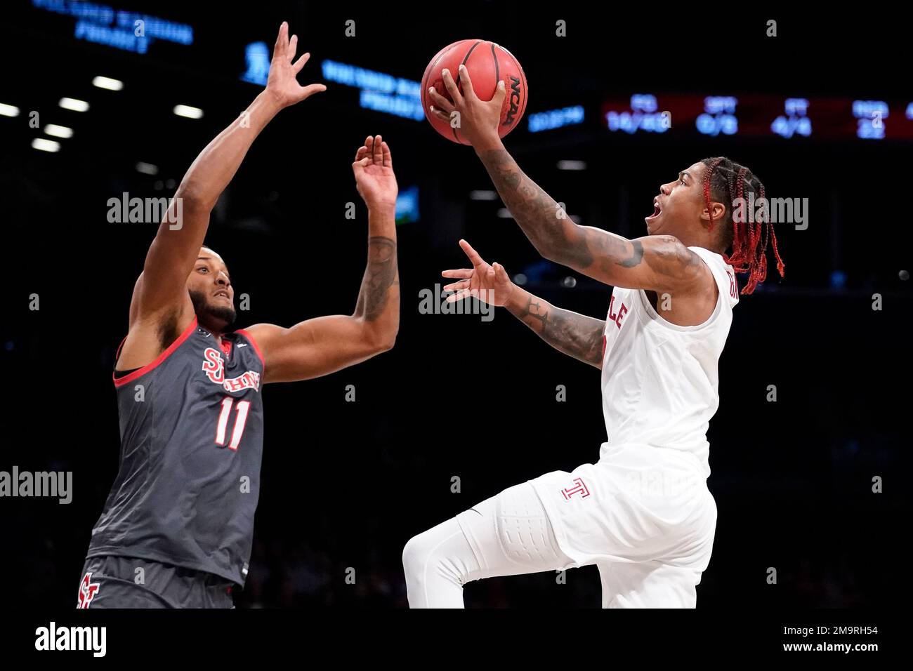 Temple's Khalif Battle, right, shoots against St. John's Joel Soriano