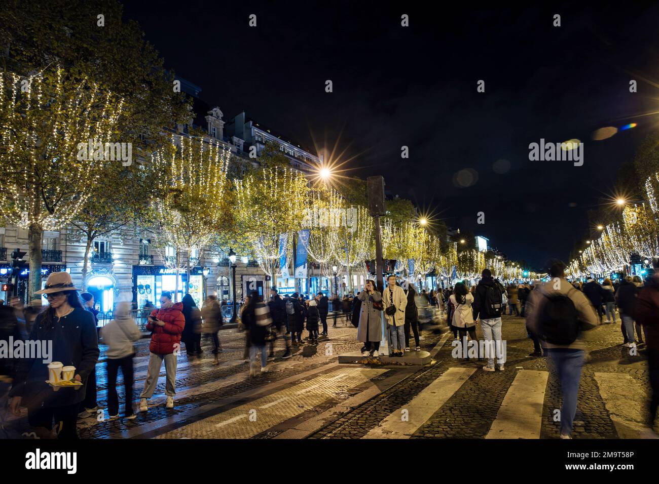 Spectators gather to attend the Champs Elysee Avenue illumination