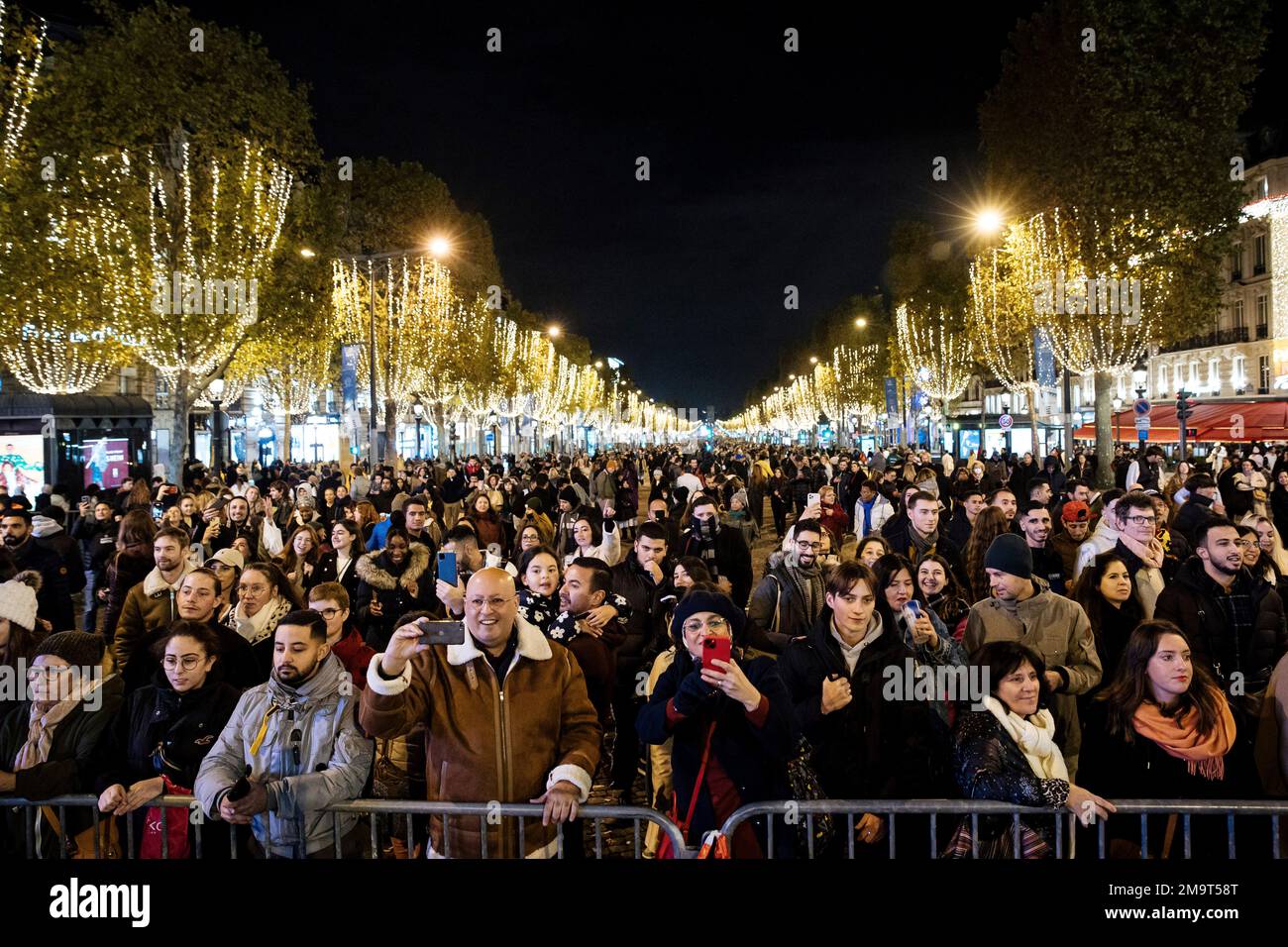 Spectators gather to attend the Champs Elysee Avenue illumination