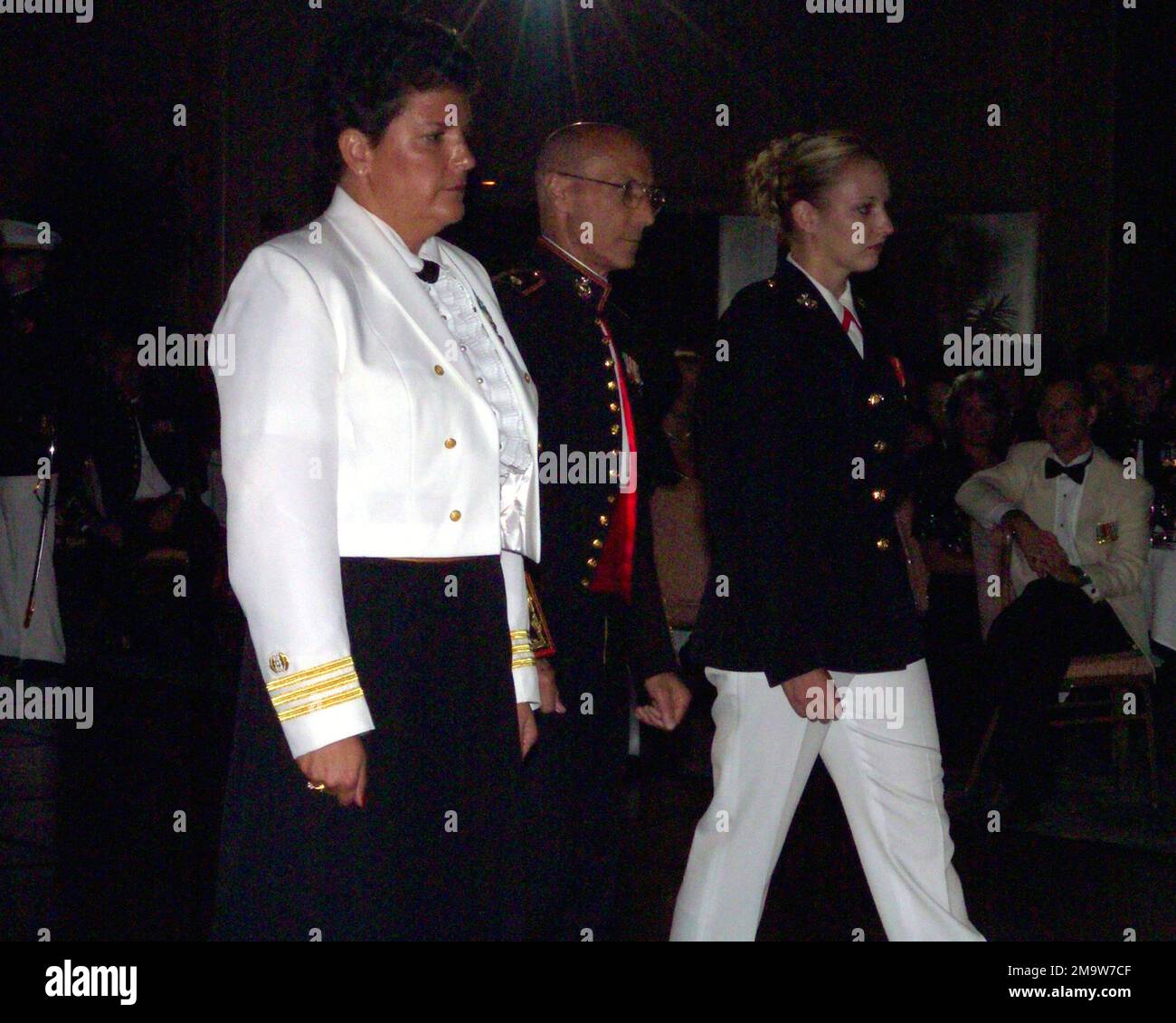 OFFICIERS DU corps DES Marines DES ÉTATS-UNIS (USMC) deuxième lieutenant (2LT) M.L. Halligan, à droite et Major (MAJ) S. P. Pike, au centre, escorte un commandant de la Marine américaine (USN) (CMD) pour recevoir un gâteau d'anniversaire, au bal des officiers de l'USMC, célébrant le 228th anniversaire de la fondation du corps des Marines. Base: Camp H. M. Smith État: Hawaii (HI) pays: Etats-Unis d'Amérique (USA) Banque D'Images