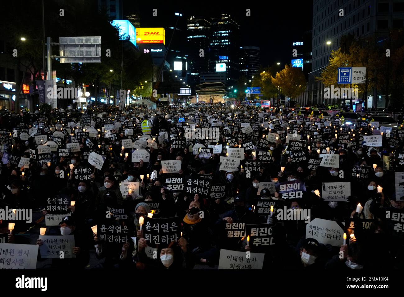 People attend a candlelight vigil for victims of Halloween crowd crush in Seoul, South Korea