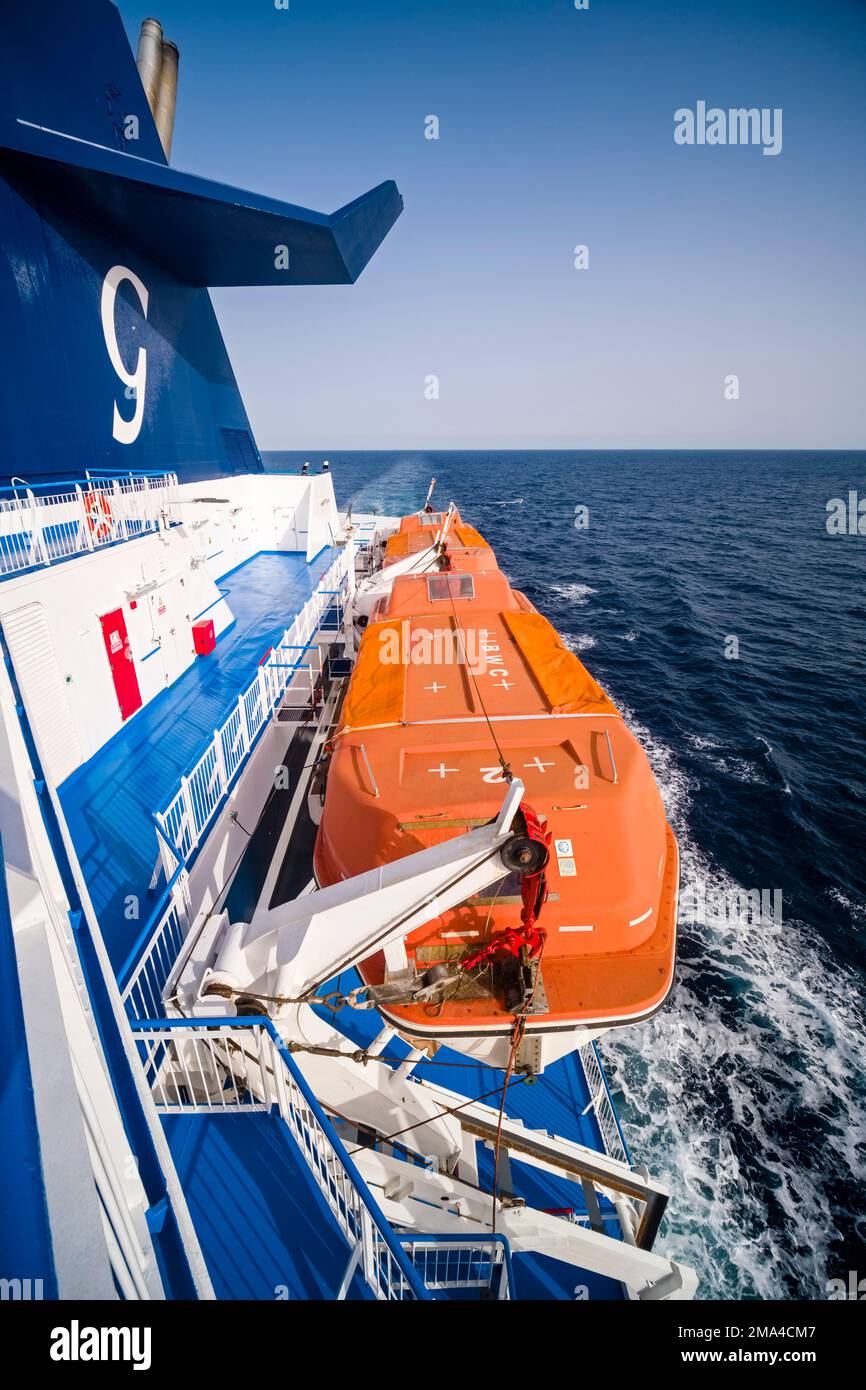 Un canot de sauvetage orange attaché au pont supérieur du ferry croisière Ausonia sur son chemin de Livourne à Palerme. Banque D'Images