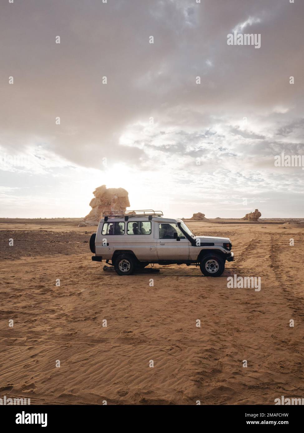 Vieille jeep d'argent 4x4 pendant une matinée nuageux dans le désert blanc, Egypte. Banque D'Images