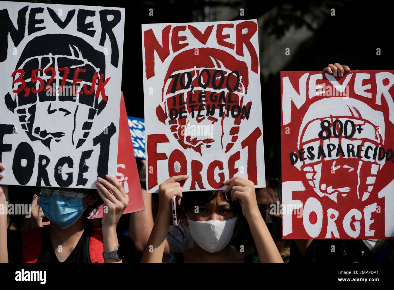 Protesters Hold Slogans As They Mark The 50th Anniversary Of Martial ...