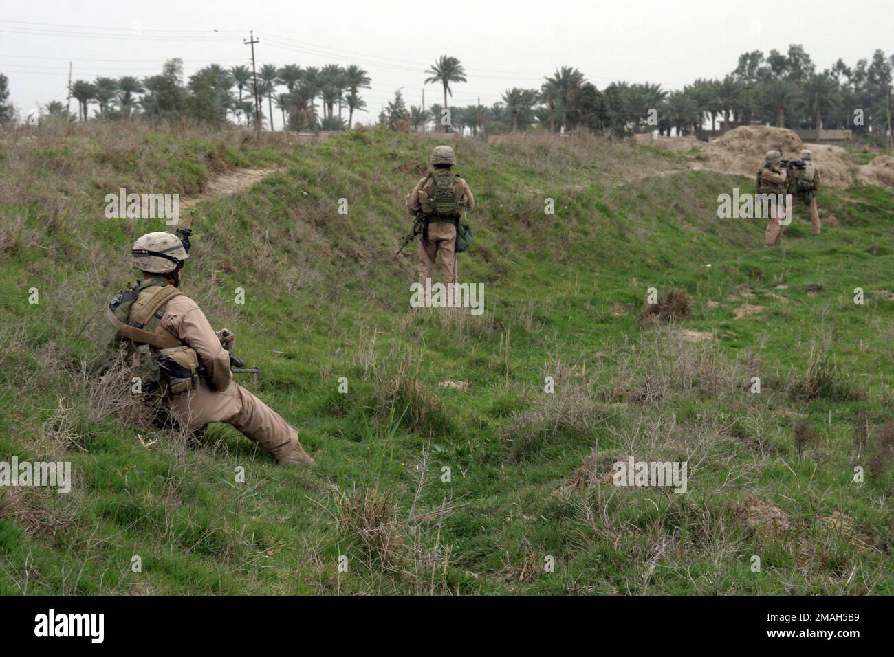 070324-M-6412C-039. [Complete] Légende de la scène : U.S. Marines avec 3rd peloton, Compagnie E, 2nd Bataillon, 7th Marines prennent la couverture derrière une colline pendant l'opération Zaidon II sur 23 mars 2007. La Force opérationnelle 2nd Bataillon, 7th Marines mène l'opération Zaidon II à Zaidon, en Irak, pour débarrasser la ville des forces anti-iraquiennes et leur refuser de continuer à utiliser la zone à l'avenir. L'équipe de combat régimentaire 6 est déployée avec les Forces nationales multi-Ouest pour appuyer l'opération liberté iraquienne dans la province d'Anbar en Iraq afin de développer les forces de sécurité iraquiennes et de faciliter le développement de l'état de droit officiel par la démonstration Banque D'Images