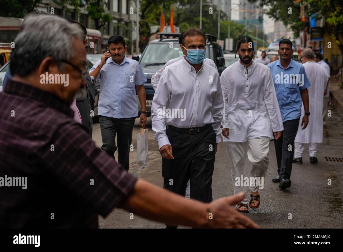 Anil Ambani, center, Chairman of Reliance Group arrives to attend the