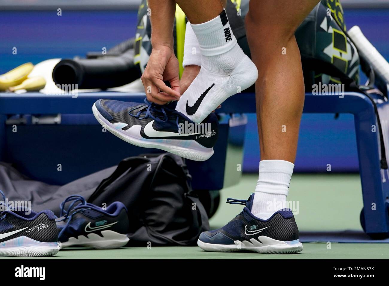 Carlos Alcaraz, of Spain, changes his shoes during a break in play against  Jenson Brooksby, of the United States, during the third round of the U.S.  Open tennis championships, Saturday, Sept. 3,
