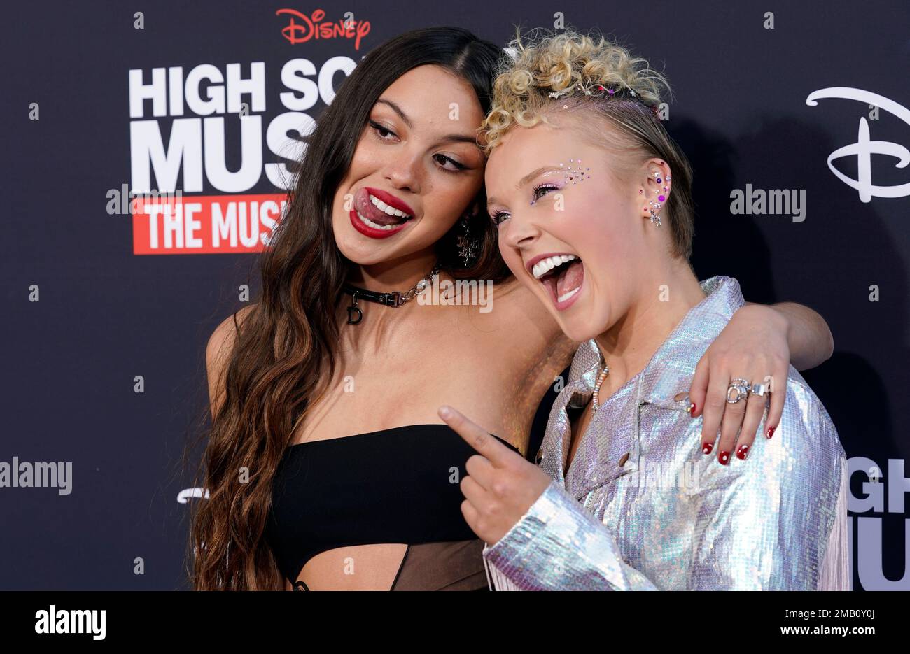 Olivia Rodrigo, left, and Jojo Siwa, cast members in "High School Musical:  The Musical: The Series," mug for the cameras at the season three premiere  of the Disney+ streaming series, Wednesday, July