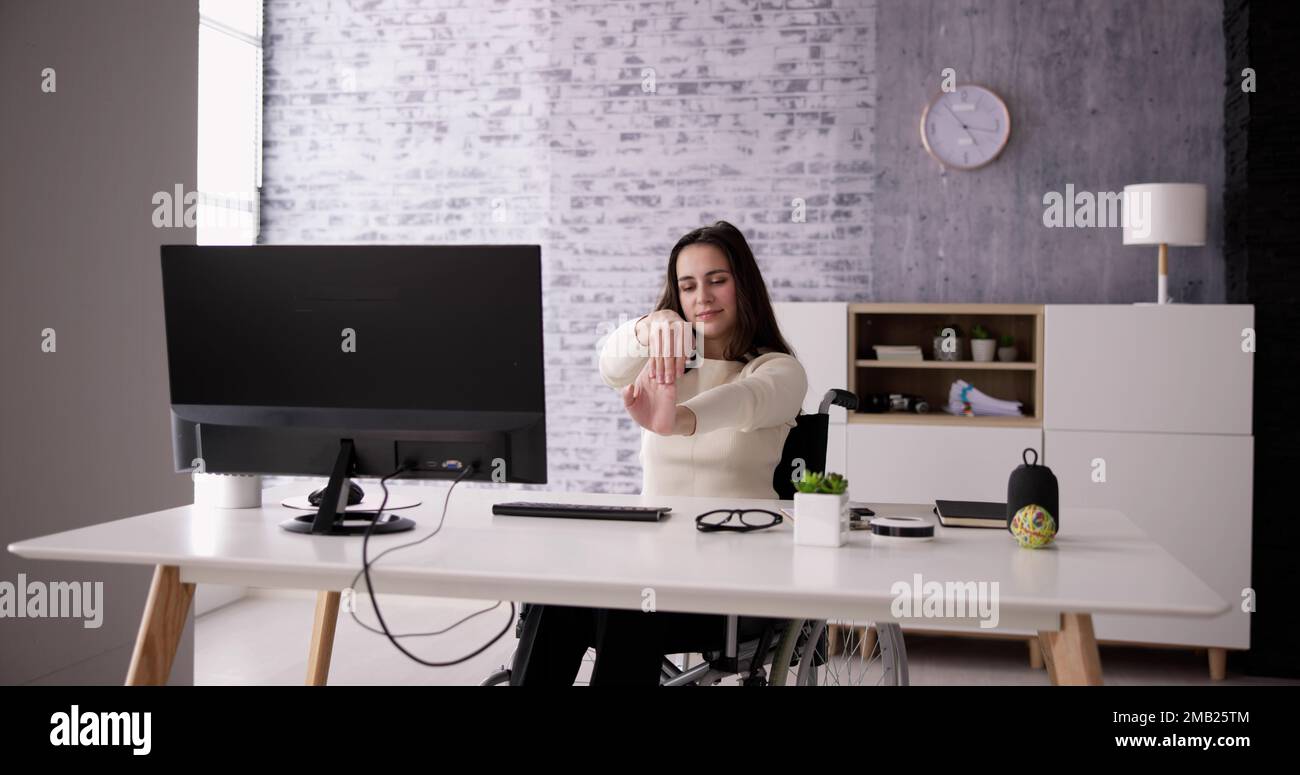 Exercice d'étirement des bras assis au bureau Banque D'Images