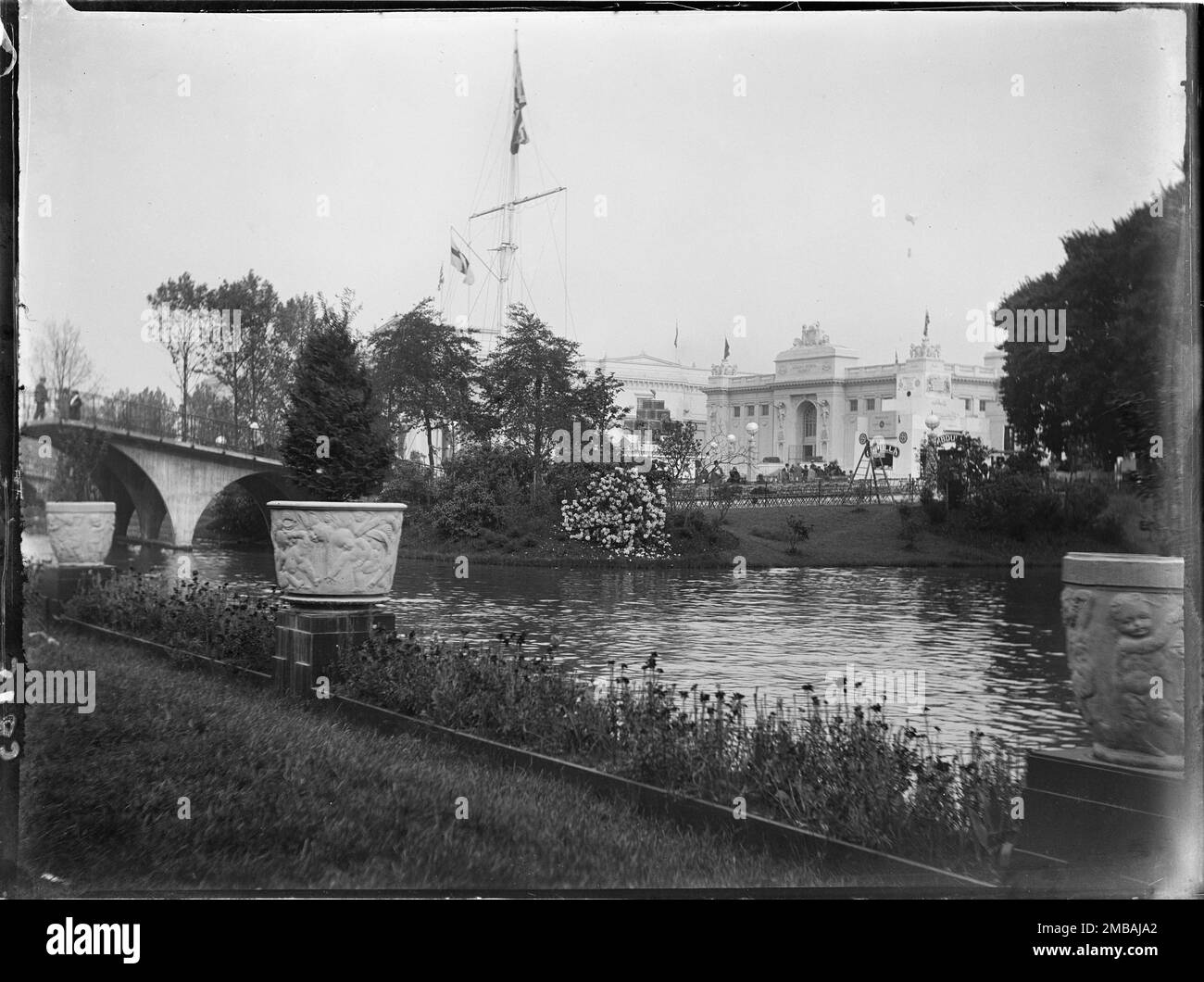 Wembley Park, Brant, Greater London Authority, 1924. De grands pots de plantes bordant le lac à l'exposition de l'Empire britannique à Wembley Park, avec un flagstaff à distance moyenne et des salles d'exposition au-delà. L'exposition de l'Empire britannique s'est ouverte le jour de Saint-Georges 1924 dans le but de stimuler le commerce et de renforcer les liens entre les pays de l'Empire britannique. Banque D'Images