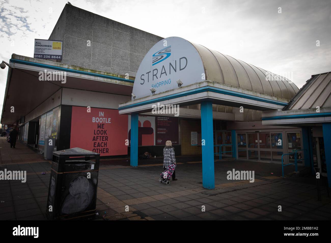 Une femme se promenant dans le centre commercial Strand de la ville de Bootle, Sefton, qui jouxte la ville de Liverpool. Il a été annoncé en 2015 que le HMRC devait fermer son bureau à Triad House à Bootle, ce qui, selon les craintes, entraînerait des pertes d'emplois dans la ville. L'installation a finalement été liquidée à la fin de 2021. Image illustrant le programme de mise à niveau du gouvernement britannique. Banque D'Images