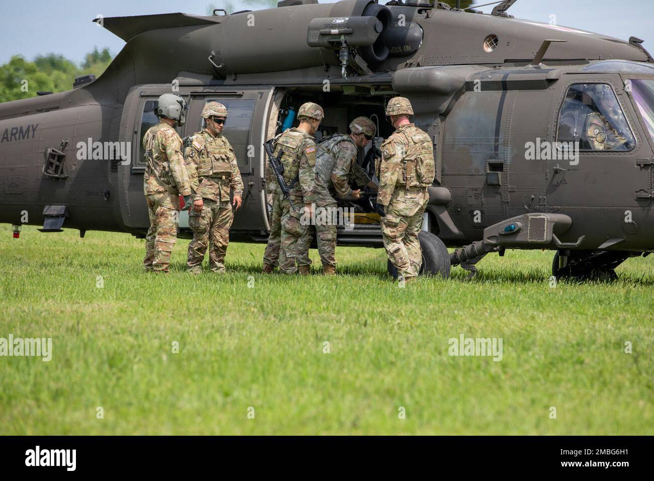 Des soldats de la 510th Compagnie des ressources humaines, du 10th Bataillon des troupes de soutien de la Division, de la 10th Brigade de soutien de la Division des montagnes, chargent une victime simulée sur un aéronef avec l’aide de 10th soldats de la Brigade de l’aviation de combat, 15 juin 2022, au cours de l’entraînement d’évacuation médicale des RH de 510th à fort Drum, New York. Banque D'Images