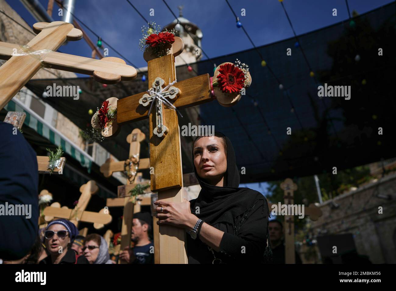 Orthodox worshippers hold crosses as they walk along the Via Dolorosa