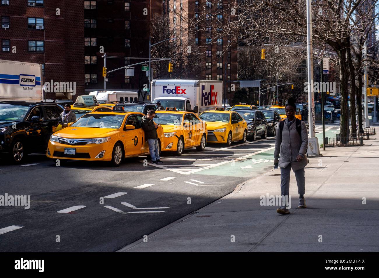 Yellow cab drivers double park for a rally calling for surcharges on