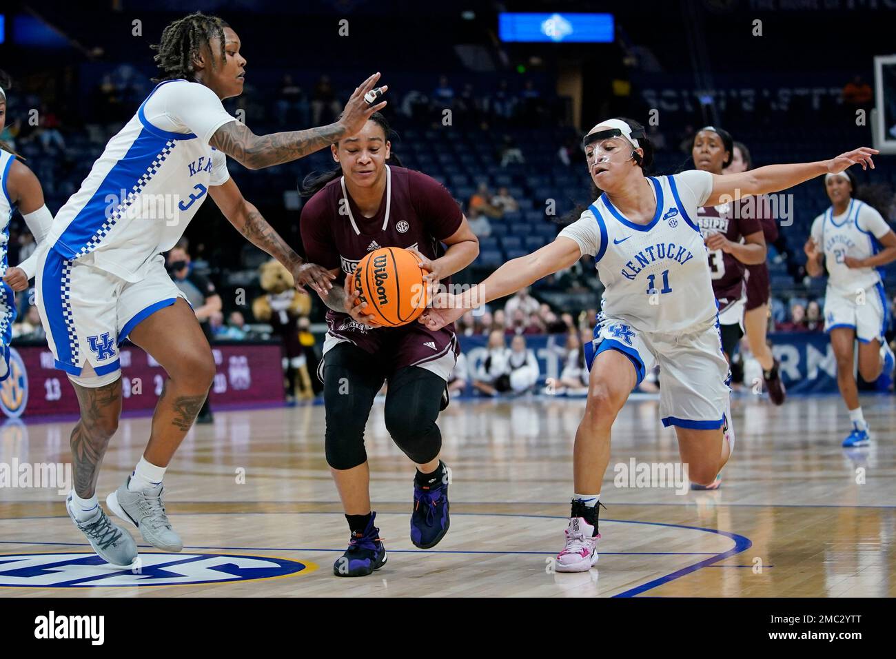 Mississippi State's JerKaila Jordan, center, drives between Kentucky's