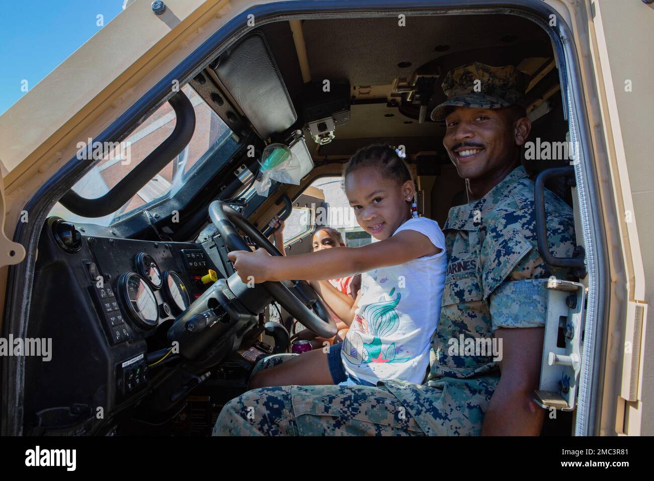 ÉTATS-UNIS Le Sgt Tevin Walker, un chef d'unité d'infanterie du 2D Bataillon, 2D Marine Regiment, 2D Marine Division, est assis dans un véhicule tactique avec sa fille dans le cadre de la journée amenez votre enfant au travail au camp Lejeune, en Caroline du Nord, au 24 juin 2022. La journée amenez votre enfant au travail est une expérience d'immersion qui permet aux membres de la famille de participer aux activités que leur membre du service effectue quotidiennement. Le but de l'événement était de promouvoir la cohésion de l'unité, le moral, l'esprit de corps et de renforcer les liens avec les membres de la famille des membres du service au sein de l'unité. Walker est un Daleville, Virginie, n Banque D'Images