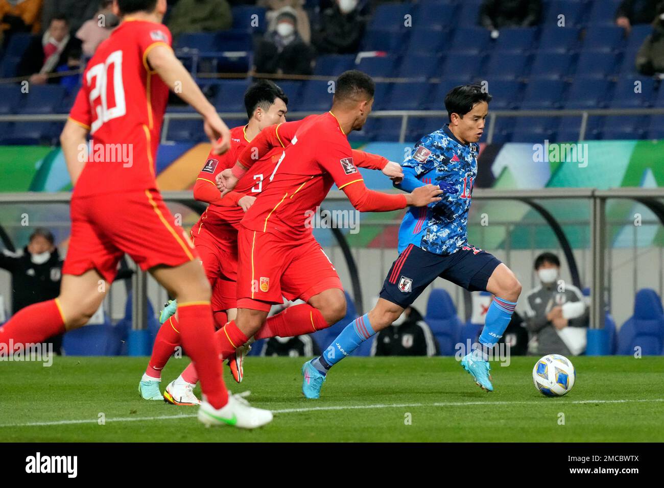 Japan's Takefusa Kubo, right, dribbles the ball during the World Cup 2022 group B qualifying soccer match between Japan and China at Saitama Stadium 2002 in Saitama, north of Tokyo, Thursday, Jan. 27, 2022. (AP Photo/Eugene Hoshiko) Banque D'Images