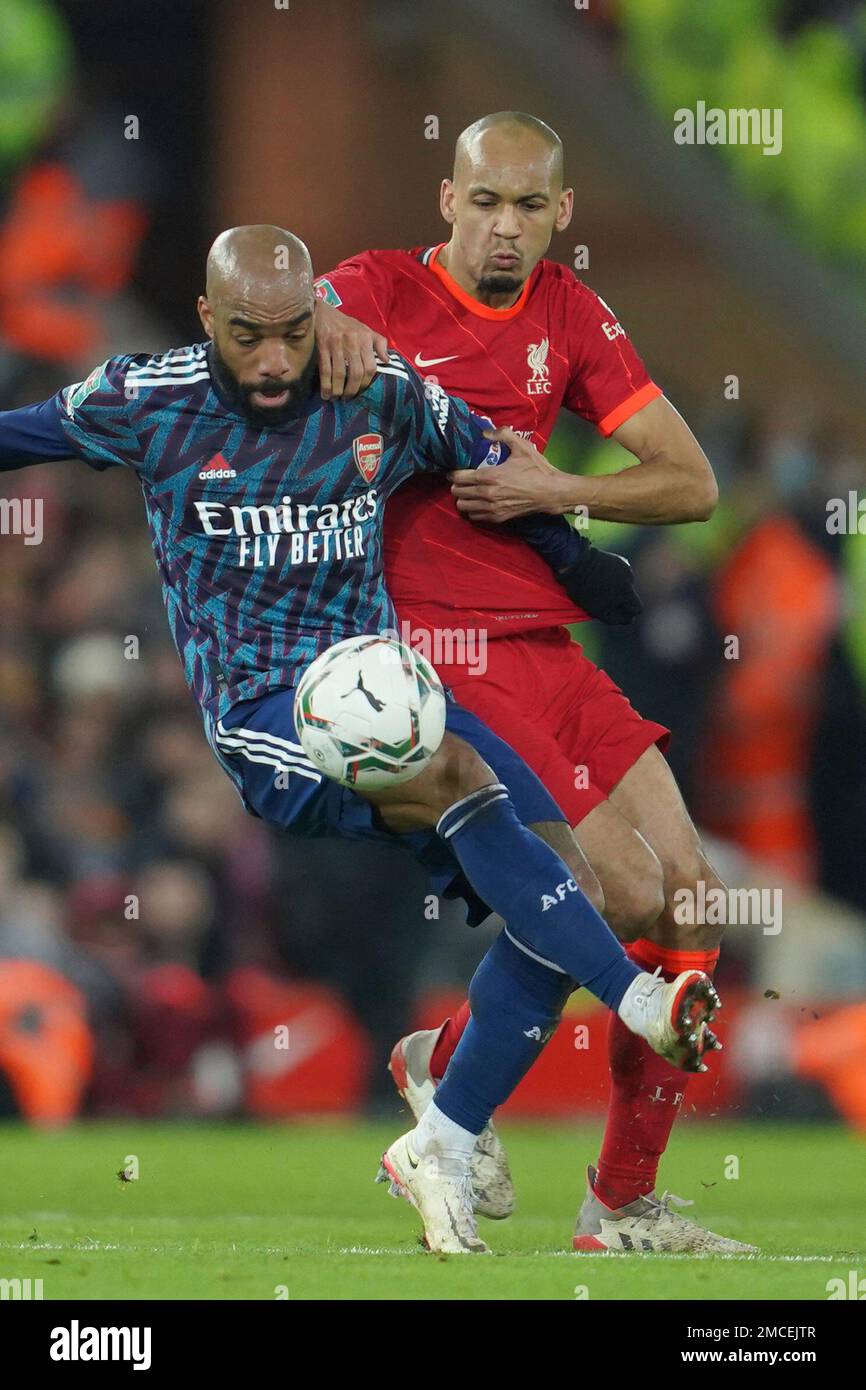 Arsenal's Alexandre Lacazette, left, challenges for the ball with Arsenal's Kieran Tierney during the EFL Cup semifinal, first leg soccer match between Liverpool and Arsenal at the Anfield Stadium in Liverpool, Thursday, Jan.13, 2022.(AP Photo/Jon Super) Banque D'Images