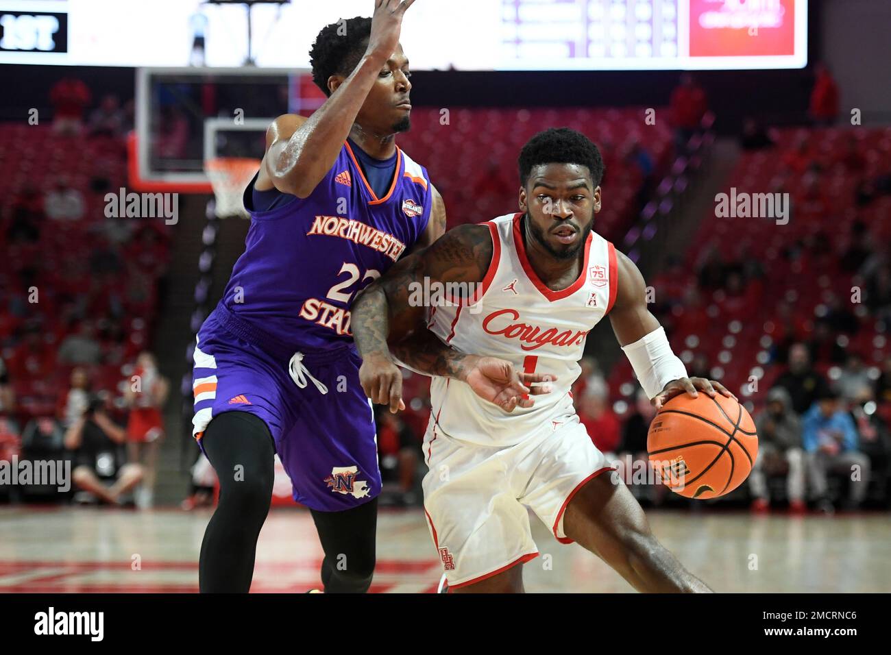 Houston guard Jamal Shead (1) controls the ball against Northwestern State guard Cedric Garrett (22) during the first half of an NCAA college basketball game Tuesday, Nov. 30, 2021, in Houston. (AP Photo/Justin Rex) Banque D'Images