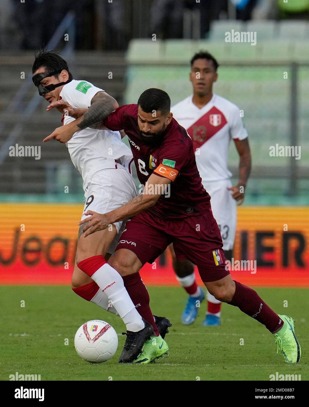Peru's Gianluca Lapadula, left, and Venezuela's Tomas Rincon battle for the ball during a qualifying soccer match for the FIFA World Cup Qatar 2022 at Olimpico Universitario stadium in Caracas, Venezuela, Tuesday, Nov. 16, 2021. (AP Photo/Ariana Cubillos) Banque D'Images