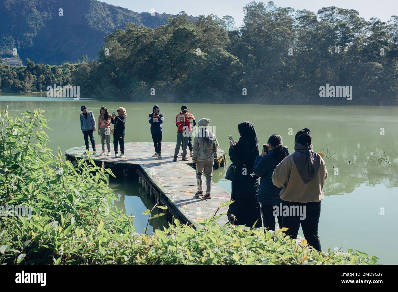 Banjarnegara, Indonésie - 21 janvier 2023: Les touristes visitent et prennent selfie sur le lac sulfurique de Telaga warna dans le plateau de Dieng. Banque D'Images