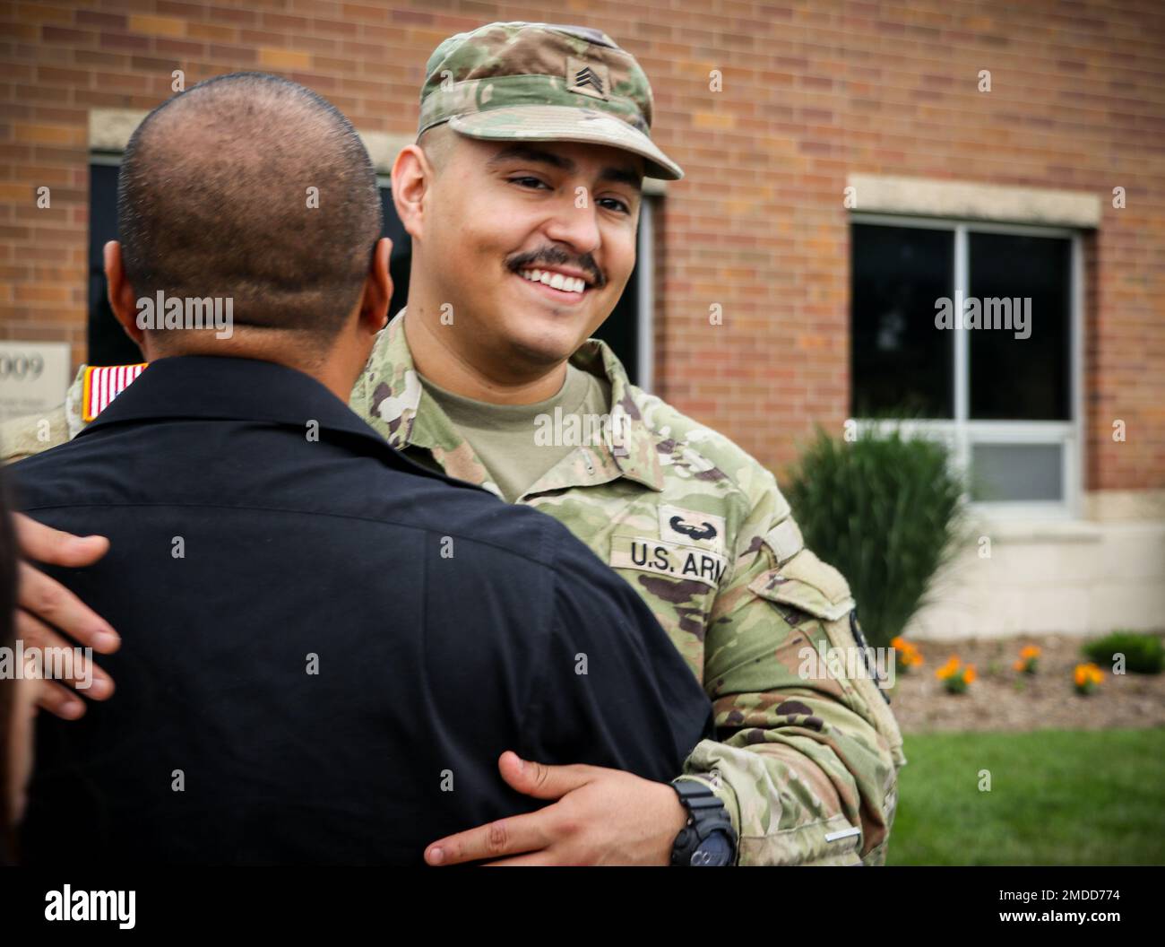 Un soldat de la Garde nationale de l'armée de l'Iowa affecté à la compagnie médicale 209th (soutien de zone) encadre un être cher après la fin d'une cérémonie d'envoi à l'école secondaire Clear Creek Amana à Tiffin, Iowa, on 16 juillet 2022. Les hauts dirigeants, la famille et les amis se sont réunis dans l'auditorium pour rendre hommage aux 80 soldats qui se mobilisent en Pologne pour appuyer l'opération Atlantique Solve. Ils fourniront un soutien aux services de santé des hôpitaux de terrain dans le cadre de la mission de présence avancée renforcée de l’OTAN, qui permet aux États-Unis d’offrir une dissuasion à leurs adversaires tout en soutenant nos partenaires de l’OTAN. Banque D'Images