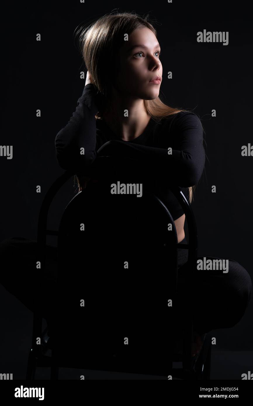 arrière-plan noir modèle femme studio jeune chaise beauté beau style pieds nus fille femelle Banque D'Images