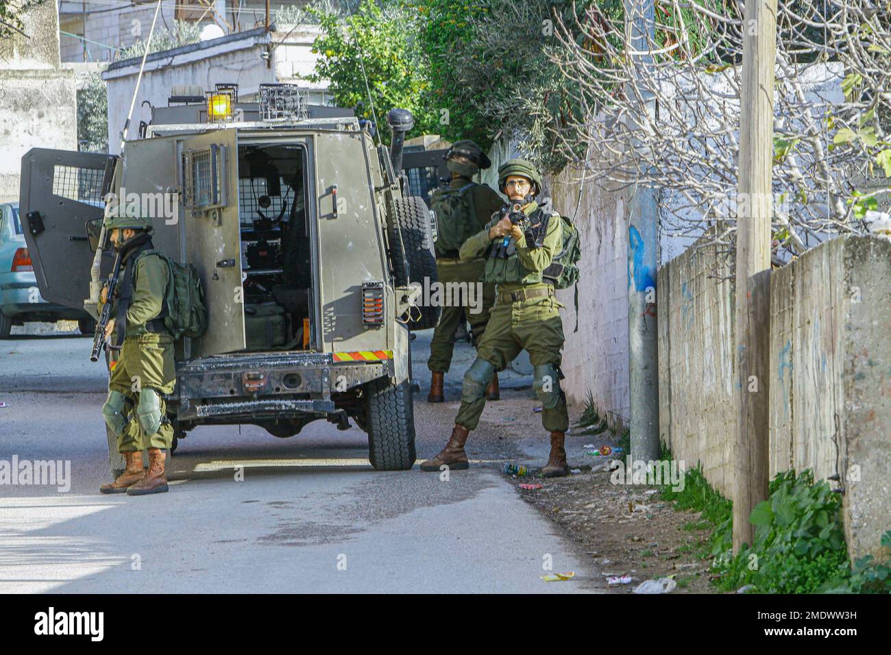 Naplouse, Palestine. 23rd janvier 2023. Les soldats israéliens se tiennent sur la garde tandis que d'autres soldats entourent et cherchent une maison, pendant le raid dans le village de Salem, à l'est de Naplouse, en Cisjordanie occupée. Les forces de l'armée israélienne se sont rompues dans le village de Salem et ont fouillé plusieurs maisons appartenant aux Palestiniens. (Photo de Nasser Ishtayeh/SOPA Images/Sipa USA) crédit: SIPA USA/Alay Live News Banque D'Images