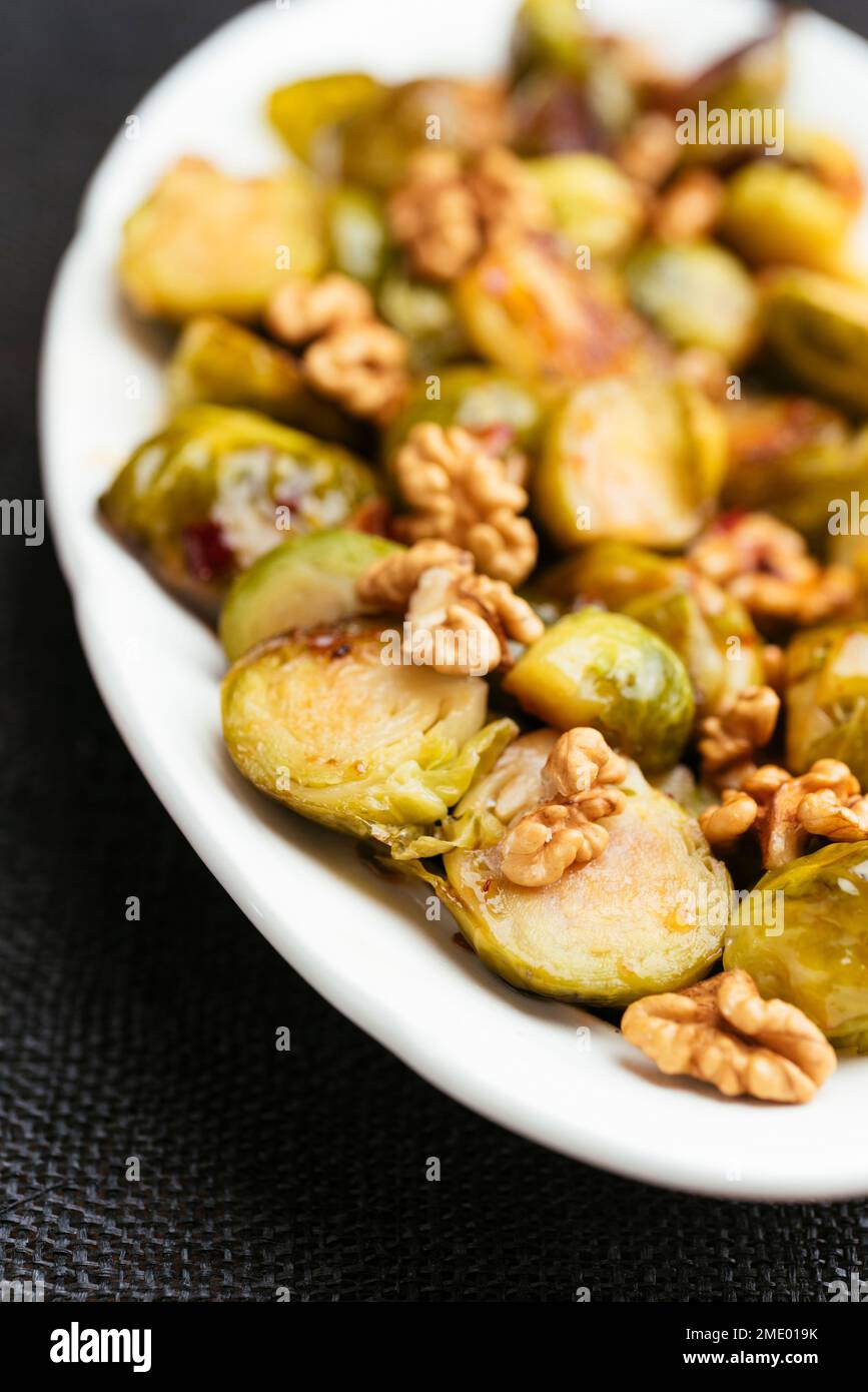 Choux de Bruxelles doux et épicés avec des noix en accompagnement. Banque D'Images