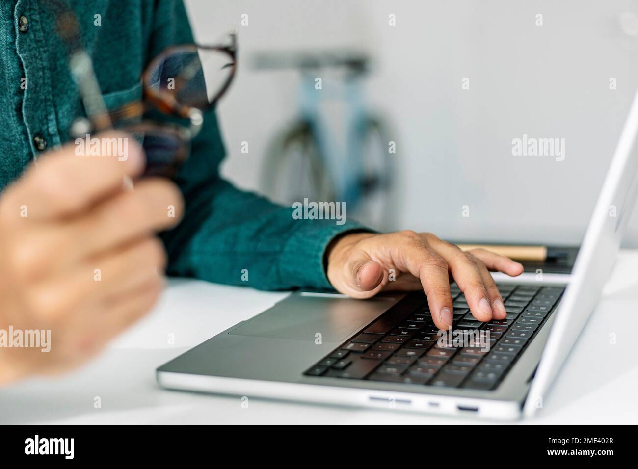 Main de freelance dactylographiant sur le clavier d'ordinateur portable au bureau Banque D'Images