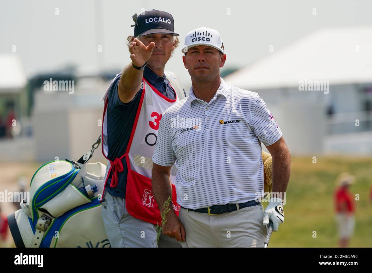 Chez Reavie, right, talks with his caddie Justin York before hitting a shot out of the rough on the 18th hole during the second round of the 3M Open golf tournament in Blaine, Minn., Friday, July 23, 2021. (AP Photo/Craig Lassig) Banque D'Images