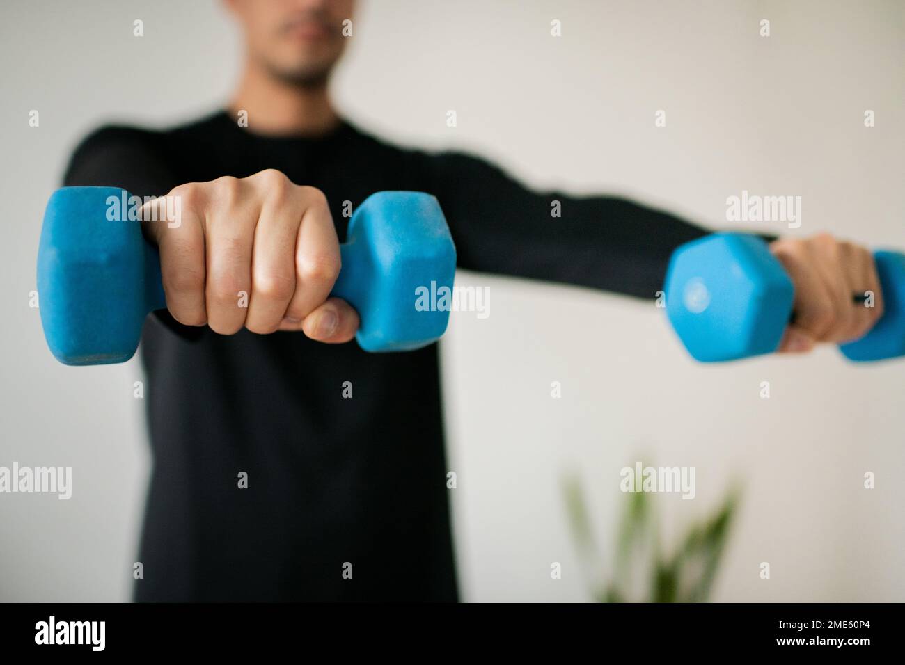 Jeunes hommes levage haltères à la maison Banque D'Images