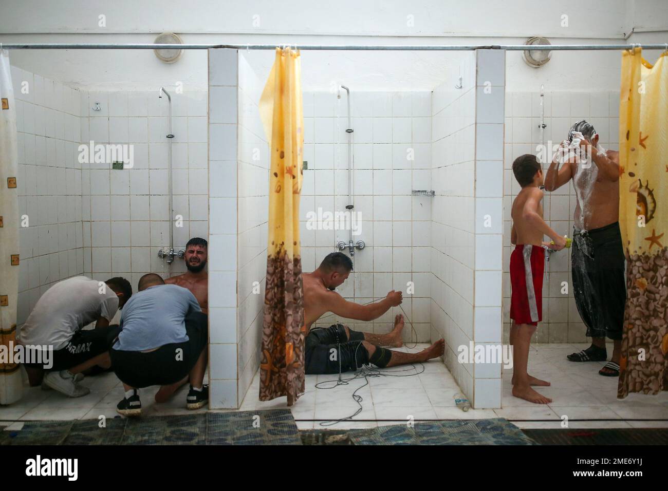 public shower boys Wrestlers try to recover on the shower room after they competed on the last  day of the 660th instalment of the annual Historic Kirkpinar Oil Wrestling  championship, in Edirne, northwestern Turkey, Sunday,