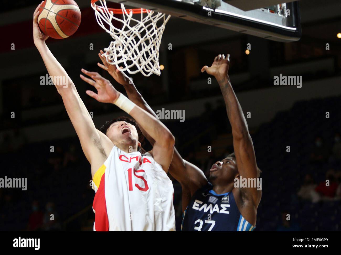 China's Zhou Qi dunks on Greece's Kostas Antetokounmpo during the first half of a FIBA men’s Olympic basketball qualifying game Thursday, July 1, 2021, in Victoria, British Columbia. (Chad Hipolito/The Canadian Press via AP) Banque D'Images