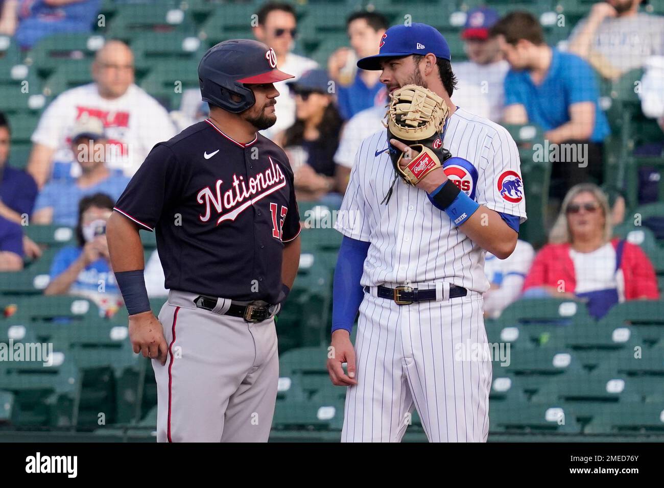 FILE - Washington Nationals' Kyle Schwarber, left, talks with former teammate, Chicago Cubs first baseman Kris Bryant, during the second inning of a baseball game in Chicago, in this May 19, 2021, file photo. Bryant's versatility, while producing offensive numbers that belong alongside his NL MVP season in 2016, is a big reason why Chicago is on top of the NL Central once again, helping the Cubs go on a 21-9 run while dealing with a rash of injuries. (AP Photo/Nam Y. Huh, File) Banque D'Images