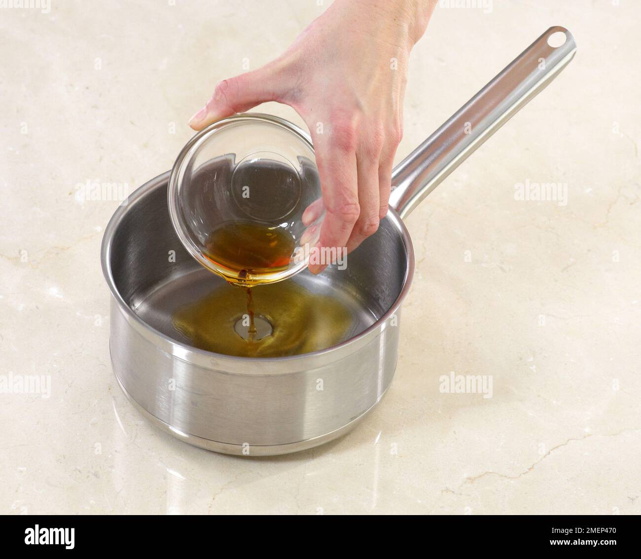 Verser le rhum dans une casserole Banque D'Images