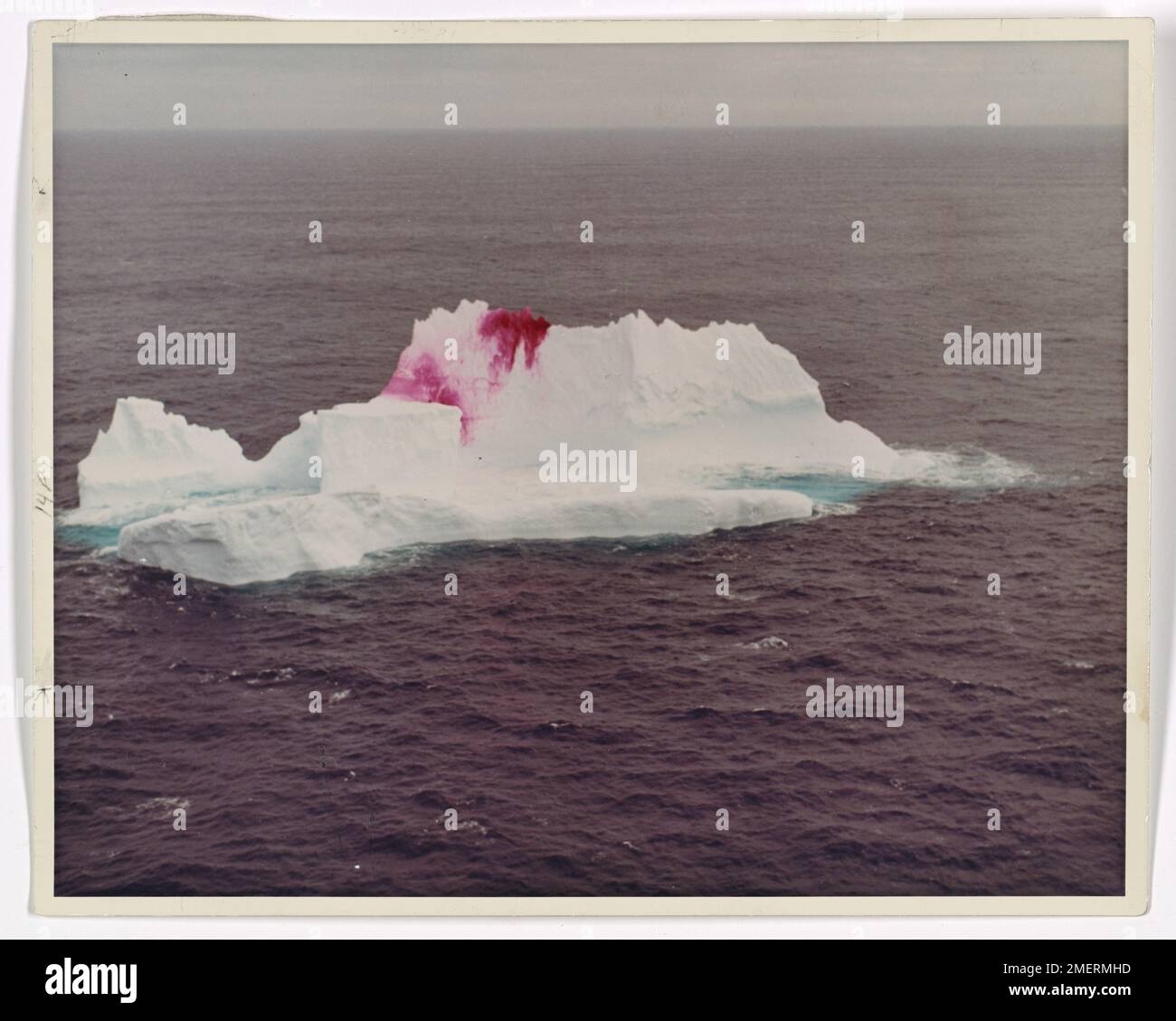 Marquage aérien de colorant Iceberg. Patrouille internationale des glaces - un iceberg au large de la côte du Labrador bombardé d'un vermillion de taches par un avion de patrouille des glaces Hercules HC-130-B de la Garde côtière. Banque D'Images