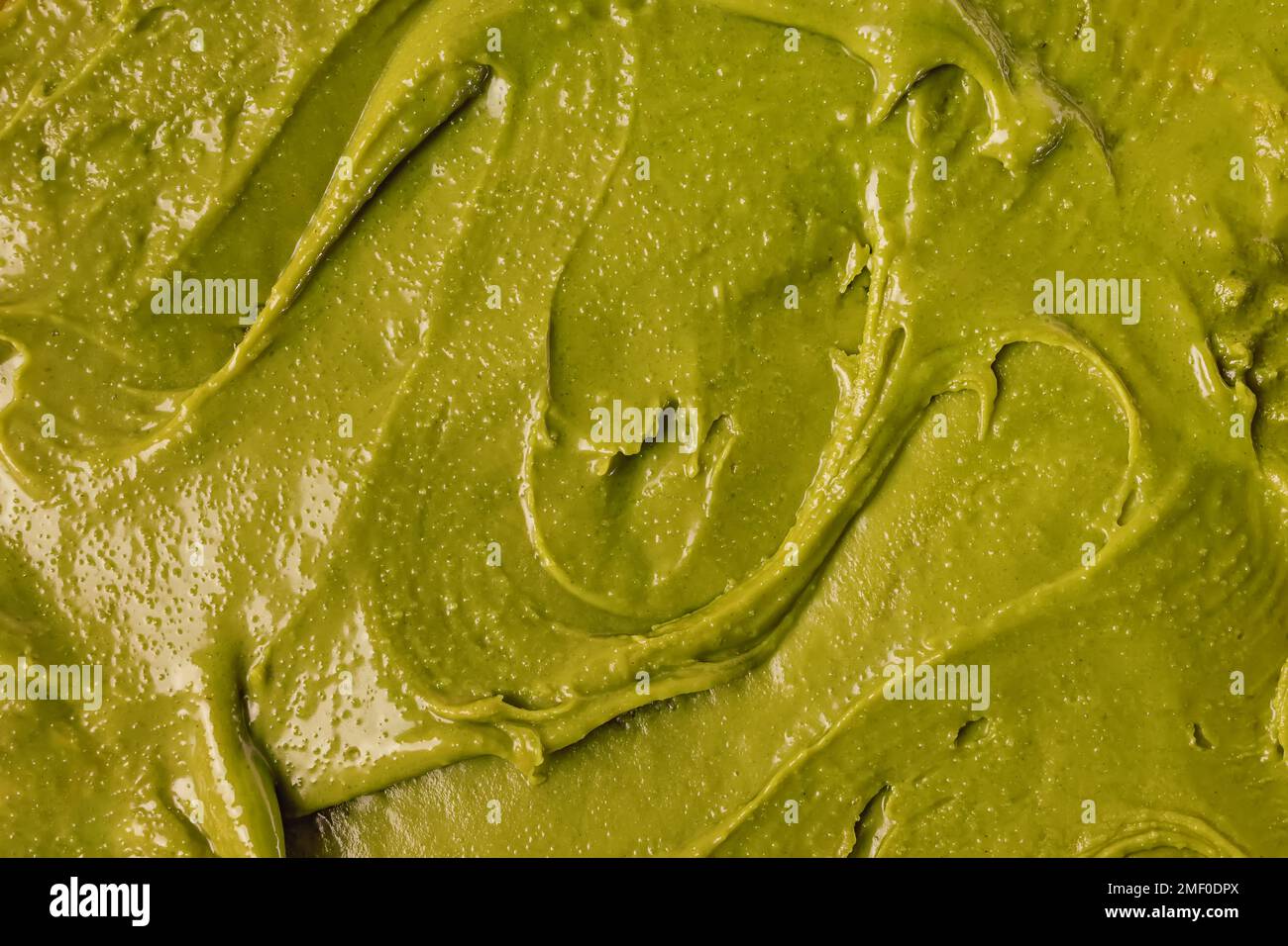 Gros plan de pâte de pistache ou de tartiner, texture de la nourriture verte Banque D'Images
