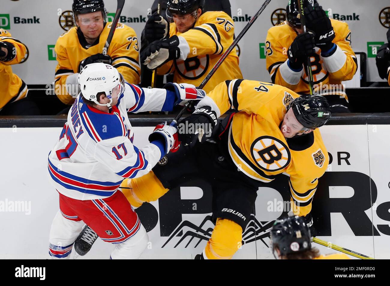 New York Rangers' Kevin Rooney (17) checks Boston Bruins' Chris Wagner (14) during the second period of an NHL hockey game, Saturday, March 13, 2021, in Boston. (AP Photo/Michael Dwyer) Banque D'Images