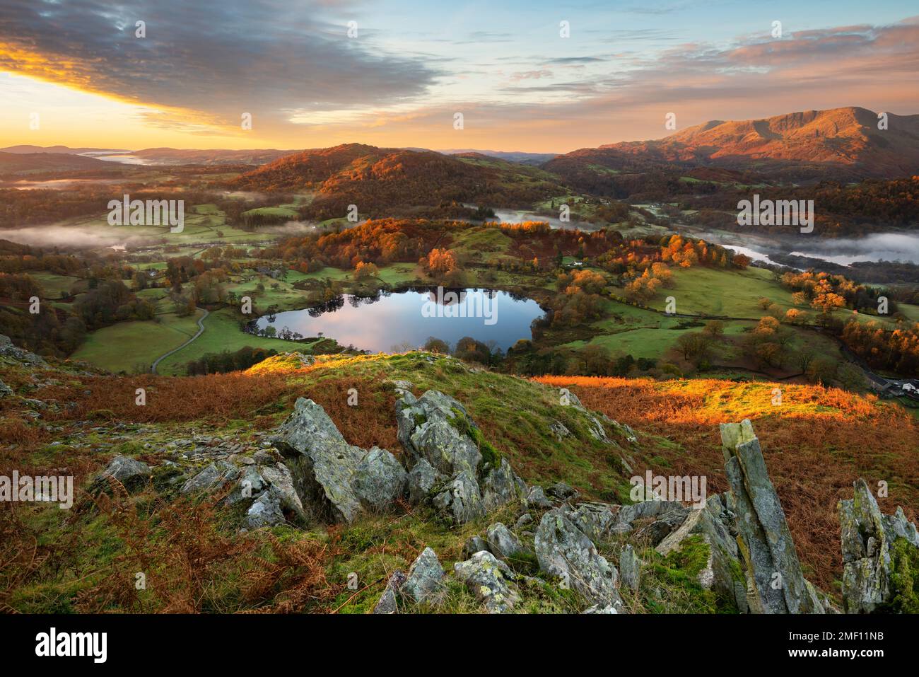 Lever de soleil en automne à Loughrigg Tarn, dans le Lake District, Royaume-Uni. Banque D'Images