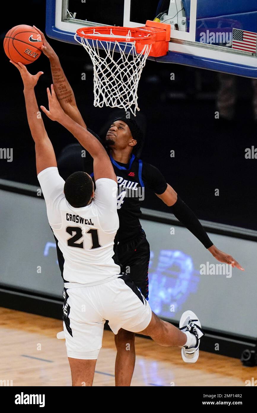 DePaul's Nick Ongenda (14) blocks a shot by Providence's Ed Croswell