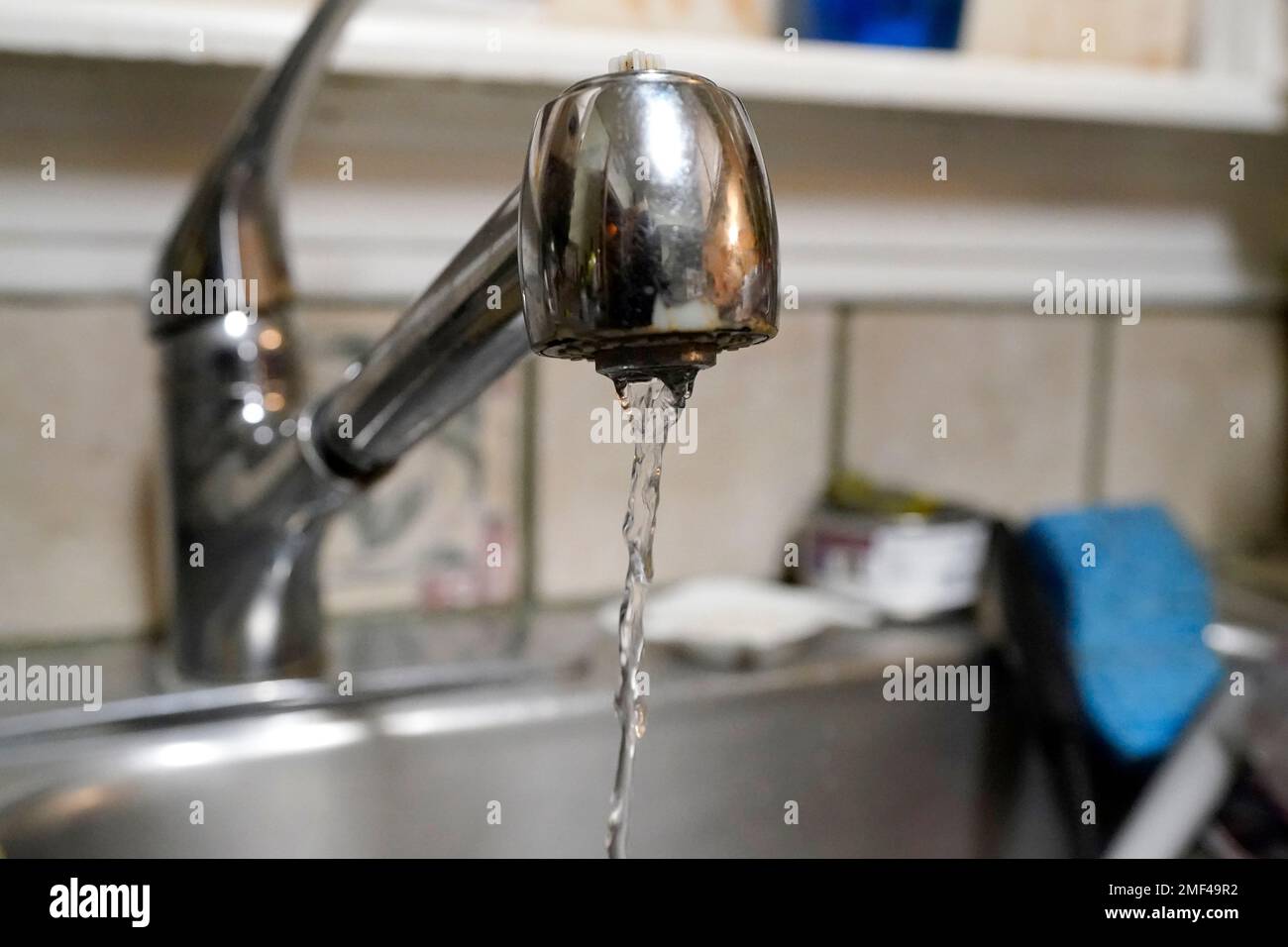 Water pours slowly out of the faucet on Saturday, Feb. 20, 2021, in