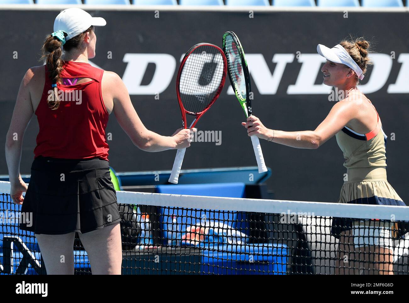 Marketa Vondrousova, right, of the Czech Republic is congratulated by Canada's Rebecca Marino after winning their second round match at the Australian Open tennis championship in Melbourne, Australia, Wednesday, Feb. 10, 2021.(AP Photo/Andy Brownbill) Banque D'Images