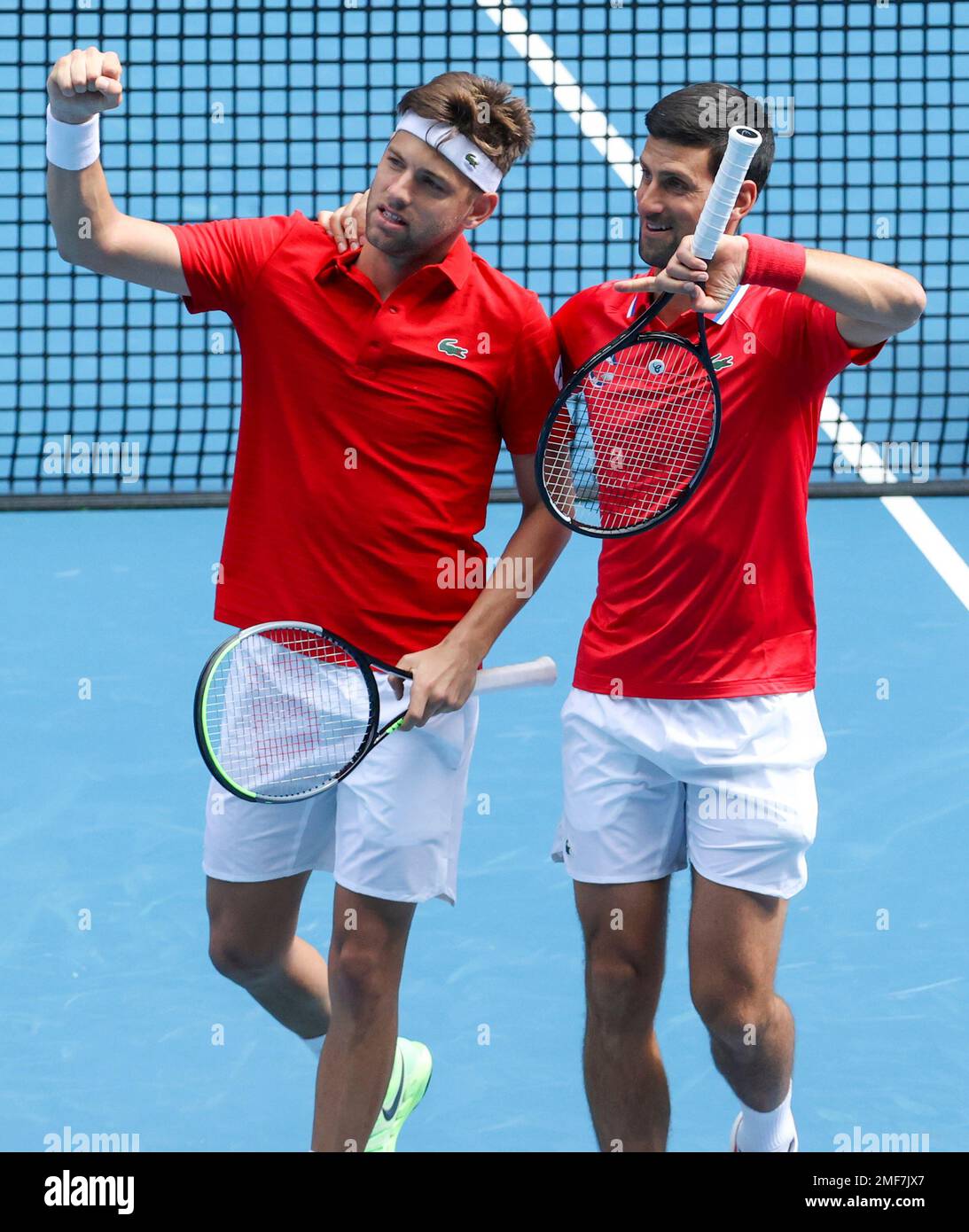 Serbia's Novak Djokovic, right, reacts with partner Filip Krajinovic after winning their ATP Cup match against Canada's Milos Raonic and Denis Shapovalov in Melbourne, Australia, Tuesday, Feb. 2, 2021. (AP Photo/Hamish Blair) Banque D'Images