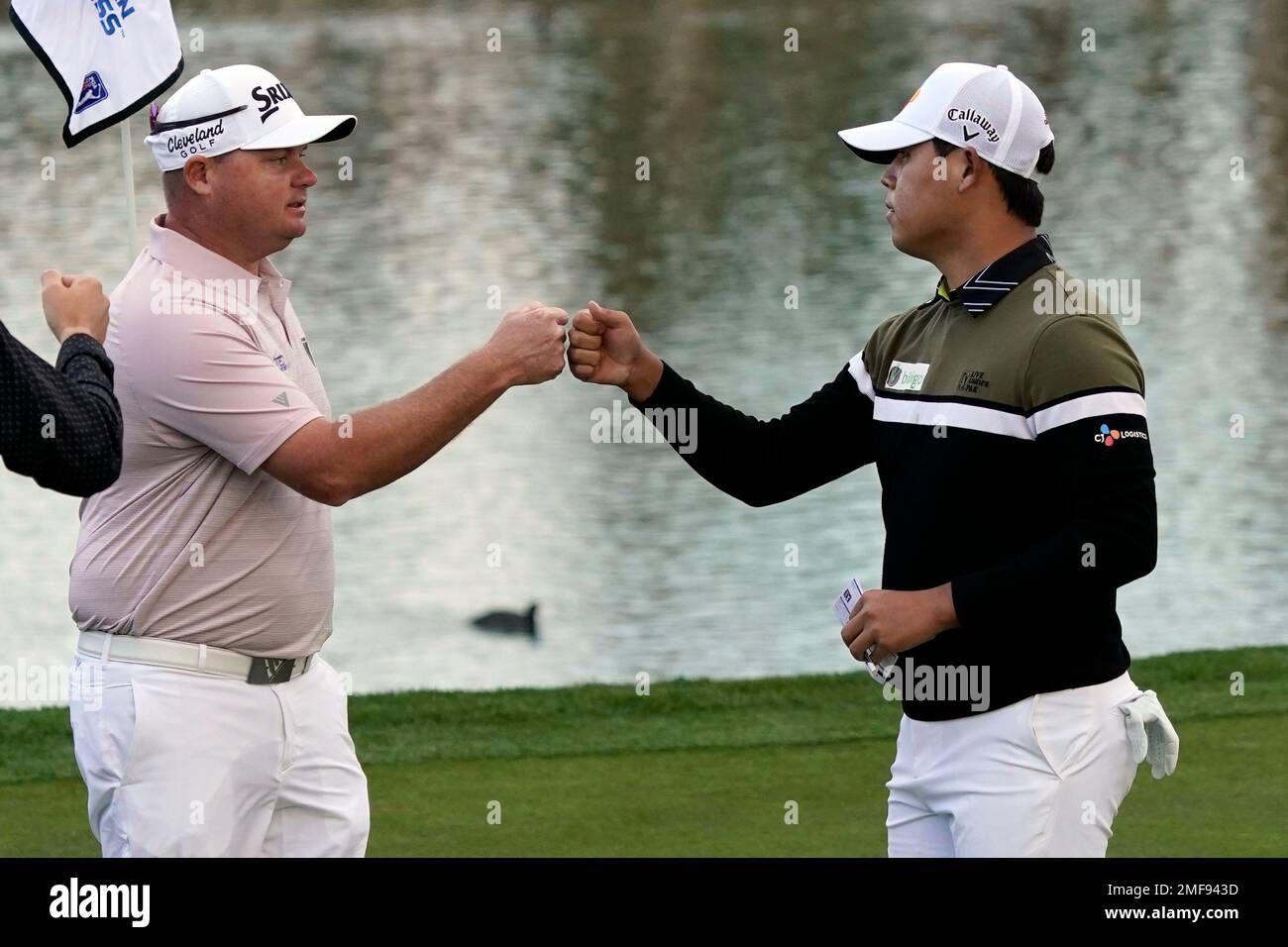 Si Woo Kim, right, bumps fists with Ted Potter Jr. after they finished the second round of The American Express golf tournament on the Nicklaus Tournament Course at PGA West, Friday, Jan. 22, 2021, in La Quinta, Calif. (AP Photo/Marcio Jose Sanchez) Banque D'Images