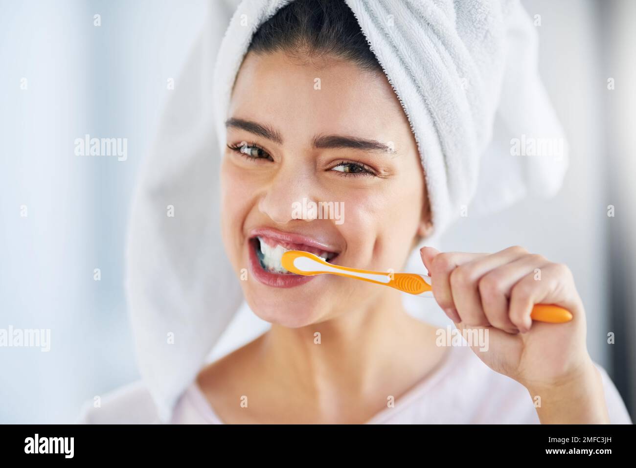 Prenez soin de votre sourire. Portrait d'une belle jeune femme se brossant les dents dans la salle de bains à la maison. Banque D'Images